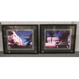 Two large framed prints depicting townscapes at night.