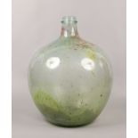 A large green glass carboy.
