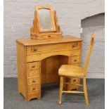 A pine dressing table and stick back chair.