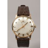 A 9ct gold automatic Marvin wristwatch with leather strap and baton markers.