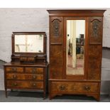 A Victorian carved flame mahogany two part bedroom suite; mirror front wardrobe and matching