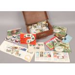 A small suitcase and contents of tea cards loose and in albums, along with a framed P.G chimp