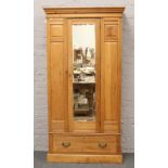 A satinwood mirror front single wardrobe over drawer base.