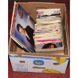 A box of L.P records and singles to include Rick Astley, Stevie Wonder, Shirley Bassey, Queen etc.
