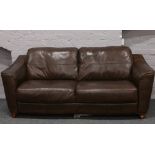 A good quality brown leather three seat sofa.
