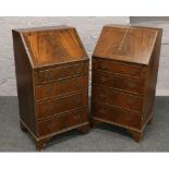 Two mahogany reproduction bureaus over four drawer chest bases.