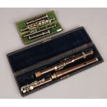 Two antique cased woodwind instruments, a piccolo and a Hawkes & Son flute.