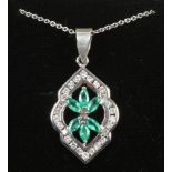 An 18ct gold emerald and diamond pendant on 14ct white gold chain.