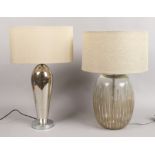 Two glass table lamps one with crackle decoration both with faun coloured shades.