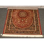 A red ground Keshan rug with medallion design, 192cm x 135cm.