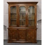 A hardwood display cabinet over cupboard base.