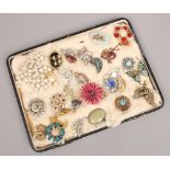 A collection of vintage brooches to include coloured and white paste stone examples.