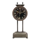 A c1920 solid brass Kee - Less Gravity clock by Watson & Webb, housing a 30 hour movement and having