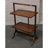 A folding mahogany two tier stand.