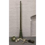 A vintage cast iron street light, along with a steel corner light and a modern garden light column