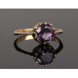 A 19th century gold ring set with a large faceted amethyst stone, size O.