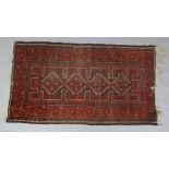 A 19th century Belouchi red ground wool rug, 100cm x 178cm.Condition report intended as a guide