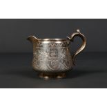 A Russian silver cream jug with double scrolling handle and gilt interior. Having wrigglework and