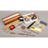 A collection of pen knives, letter openers, Ronson lighter service kit, cigarette cases and a