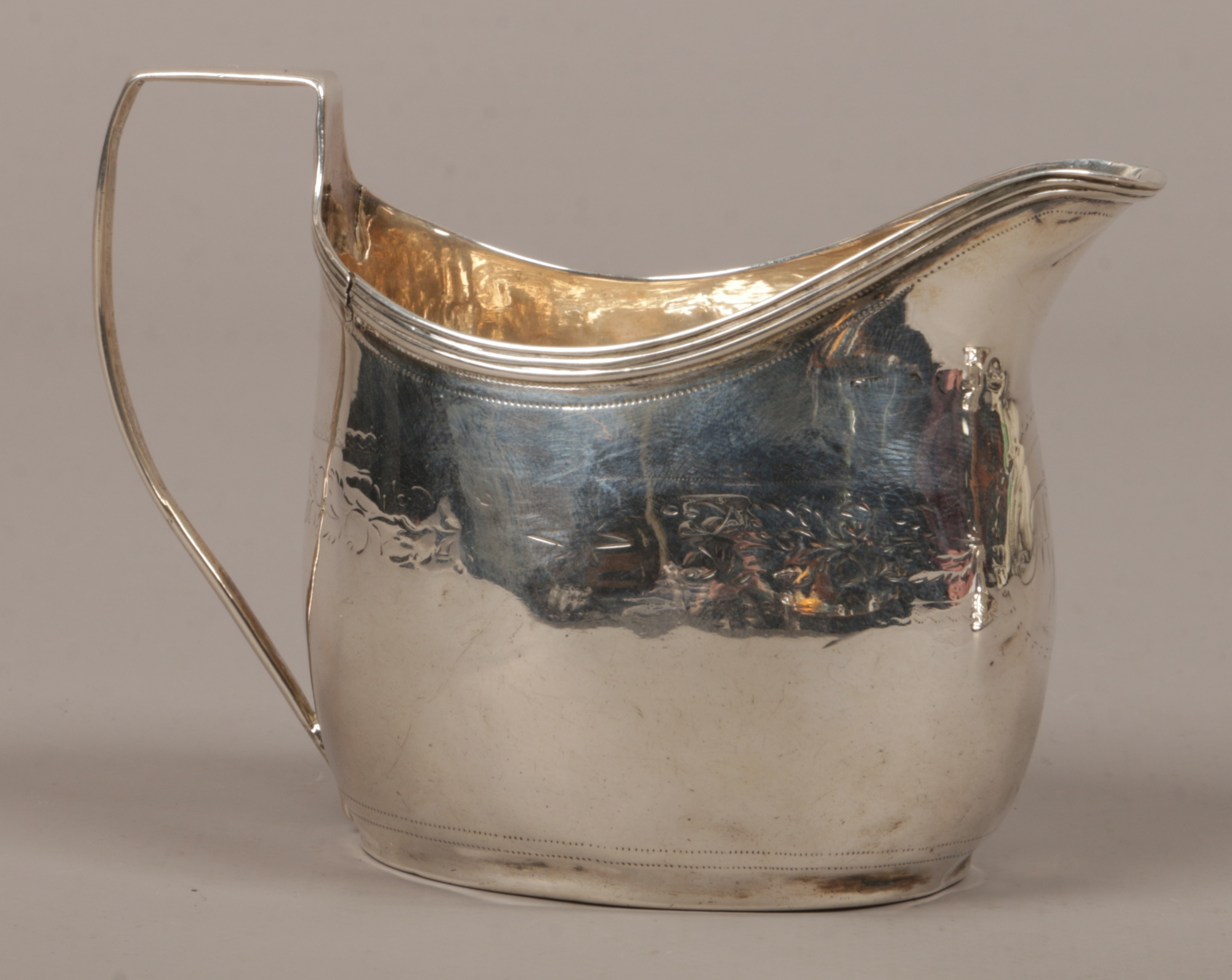 A Georgian silver cream jug assayed London partial hallmarks, 82 grams.Condition report intended