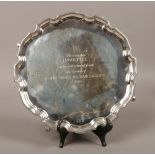 A presentation silver salver, raised on four feet assayed Birmingham 1938 by Ernest. W. Haywood, 820
