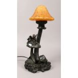 A composite figural table lamp formed as a fairy on toad stools.