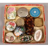 A tray of various pill boxes, along with a pair of folding spectacles in tortoise shell effect