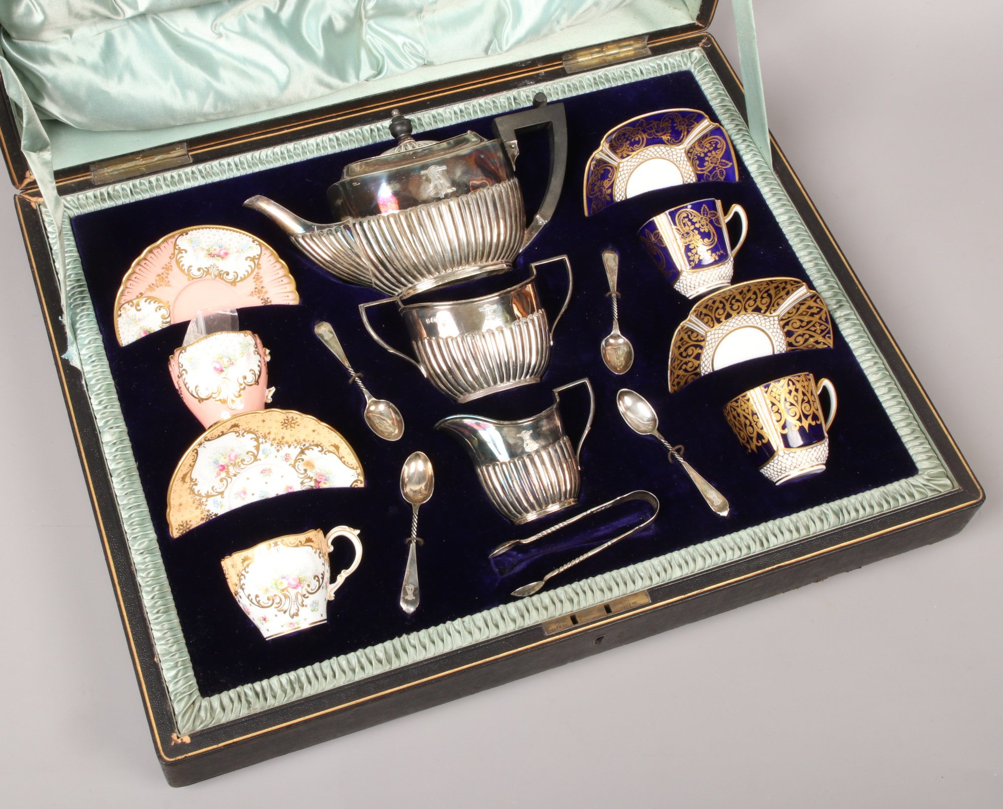 An Edwardian travelling salesman's silver and china teaset. With four Copeland Spode coffee cups and