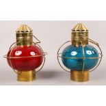 A pair of port and starboard brass hanging oil lamps with red and blue glass shades.