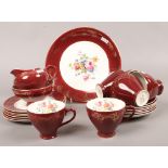 An empire bone china six part teaset with floral decoration and crimson and gilt borders.