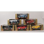 Six boxed Burago 1/18 scale Diecast metal model vehicles including Porsche, Ferrari, Dodge, BMW