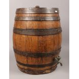 An oak iron bound barrel with tap, height 48cm diameter 24cm.