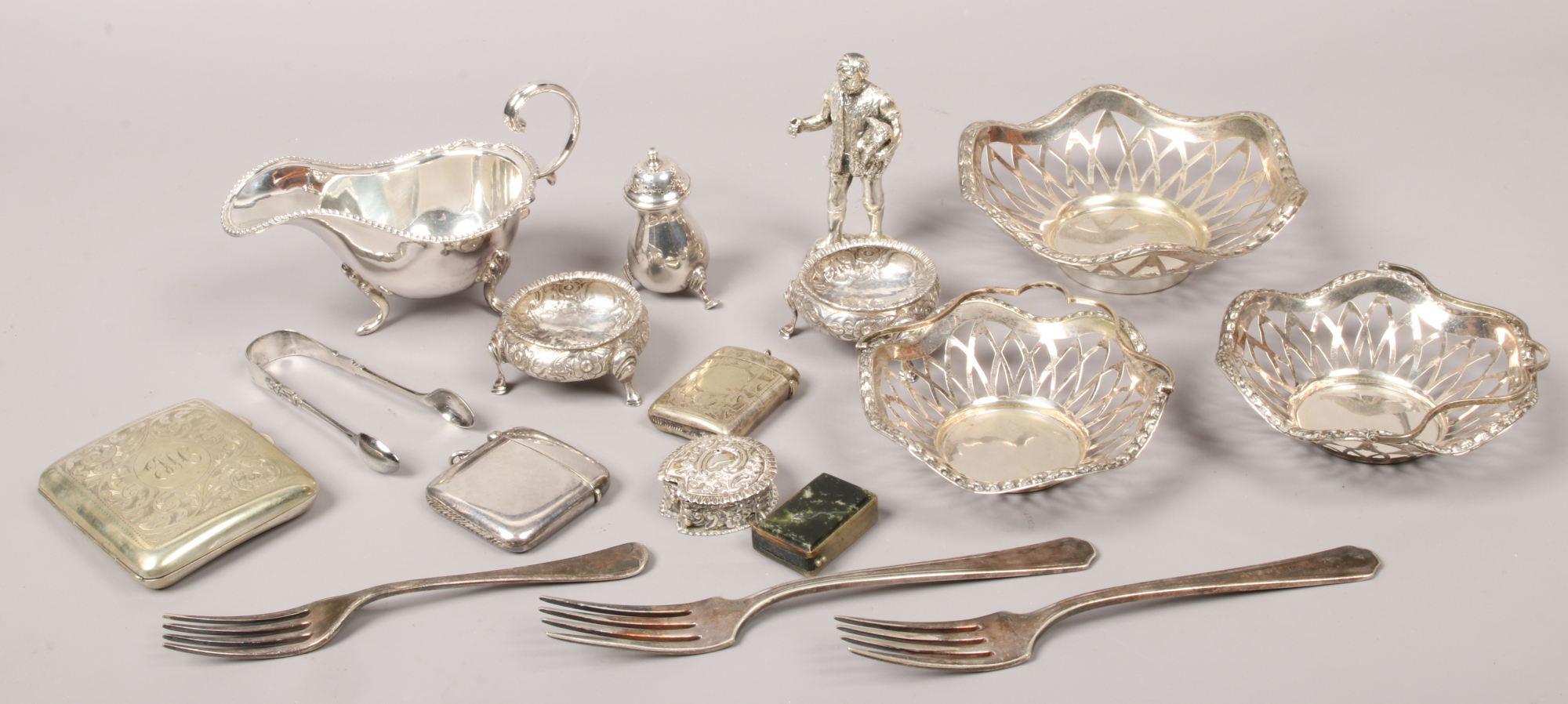 A collection of mainly silver plate items to include vesta cases, sauce boat, salt cellars, silver