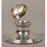 A silver Capstan inkwell with Bristol blue glass liner, assayed Birmingham 1925 by Wilmot