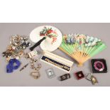 A box of collectables including hand fans, costume jewellery, lighters, make up compact etc.