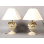 A pair of composite table lamps decorated with acorns and acanthus leaves.