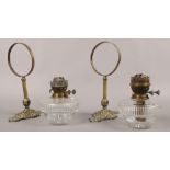 A pair of brass wall sconces with cut glass oil lamp fonts.