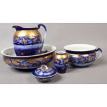 A Victorian blue ground jug and bowl set with matching chamber pot, soap dish and vase.