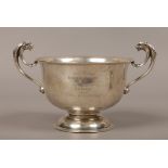 A George V silver presentation pedestal bowl with twin mask head handles, assayed Birmingham 1912 by