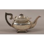 A George V silver teapot raised on four ball feet, assayed Birmingham 1916 by S. Blanckensee & Son