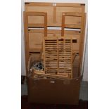 A large wooden shelving unit along with a box of wooden table top stands, lighting etc.