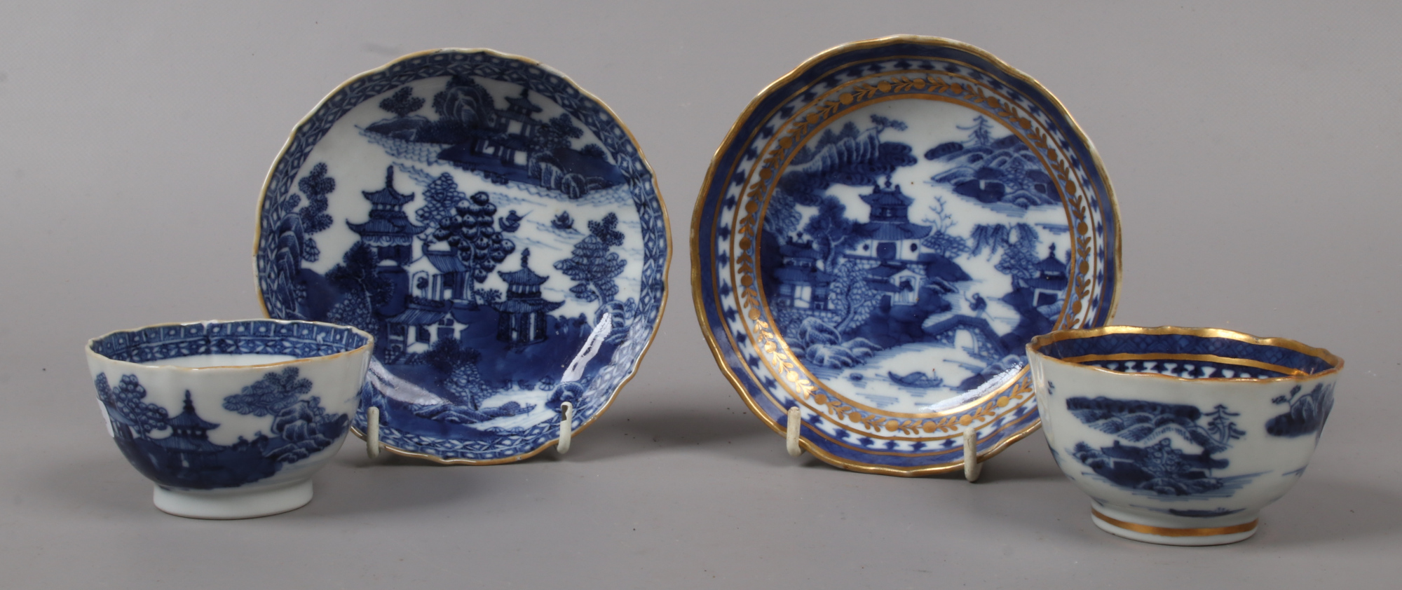 Two Chinese export blue and white tea bowls and saucers.Condition report intended as a guide only.