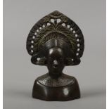 An Indian patinated bronze bust of a deity with a large headress.