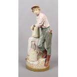 A large Royal Dux figure of a young farm worker collecting water. Decorated in pale hues. Pink