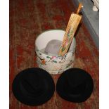 A floral hat box and contents of four hats, along with a oriental paper parasol.