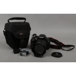 A Canon EOS 200D 24.2 mp DSLR camera with canon EF- S 18 - 55mm zoom lens and three batteries, along