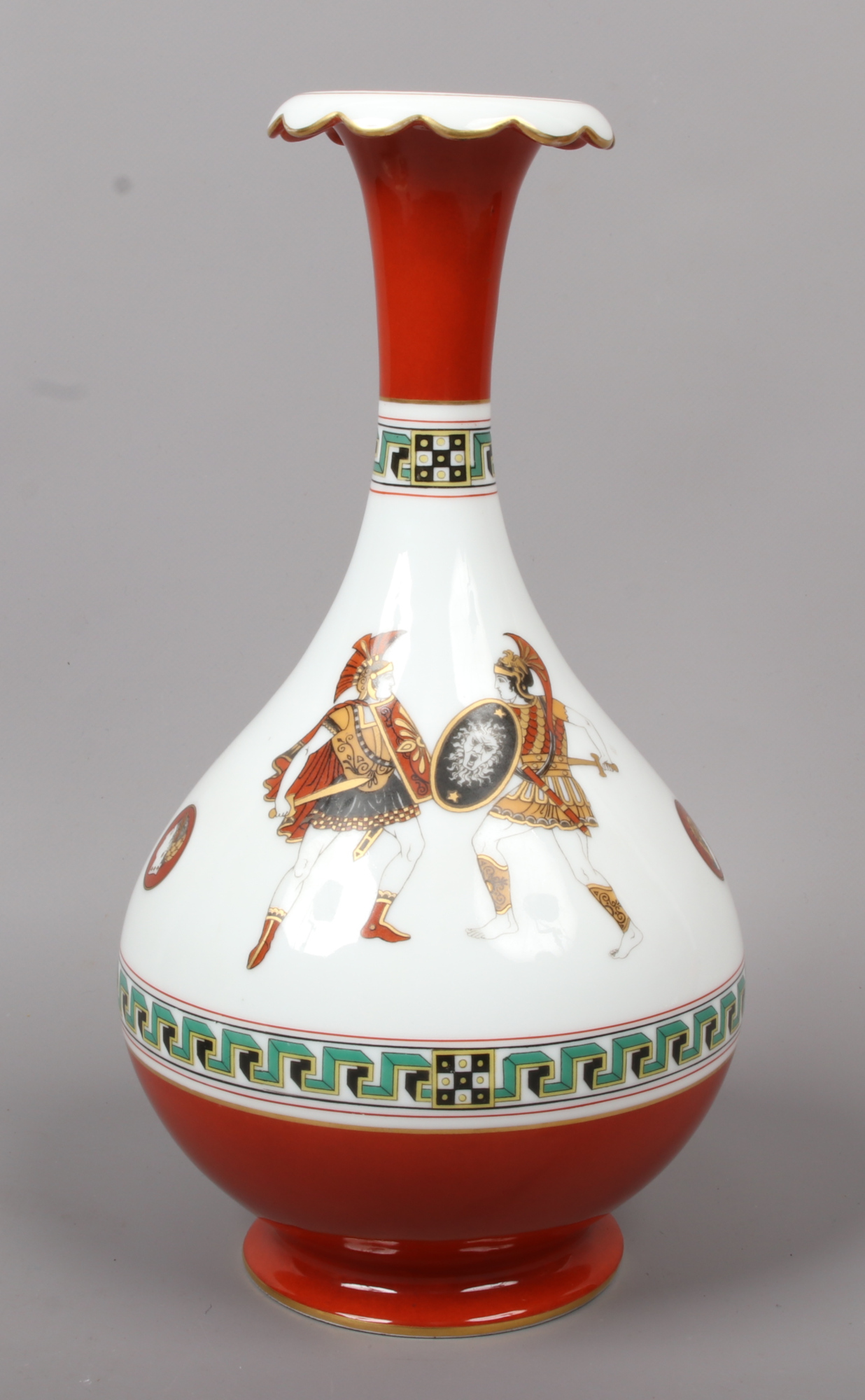 A porcelain bottle vase. With red ground and key fret borders and decorated with a continuing band