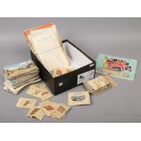 A quantity of ephemera including postcards, vintage sets of monochrome photograph snap shots,