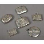 Five assorted silver vesta cases and a vinaigrette of book form.