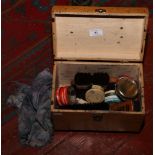 A wooden shoe shine box and contents of polish and brushes etc.